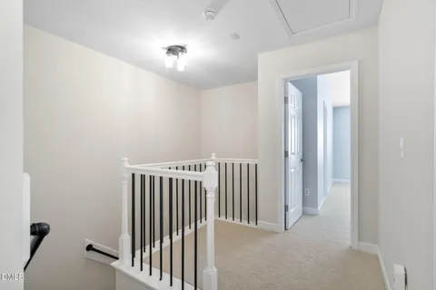 an empty room with chandelier fan