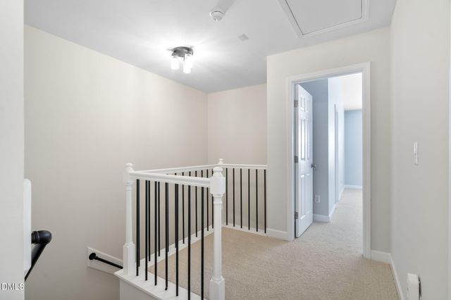 an empty room with chandelier fan