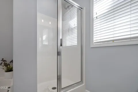 a white bath tub sitting next to a shower