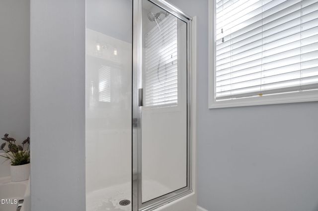 a white bath tub sitting next to a shower