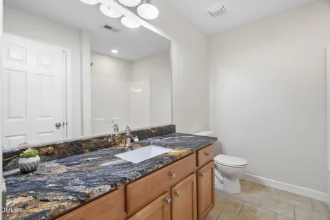 an empty room with closet and windows