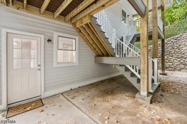 a view of a house with street and wooden fence