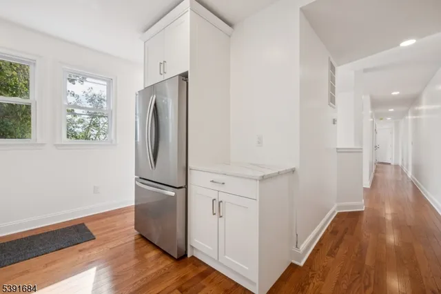 an empty room with wooden floor and a window