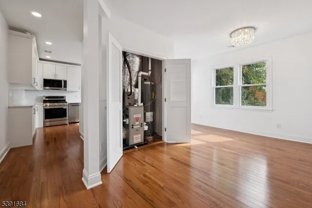 a view of a kitchen with wooden floor and a window