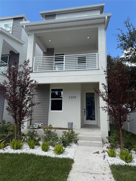 a front view of a house with garden