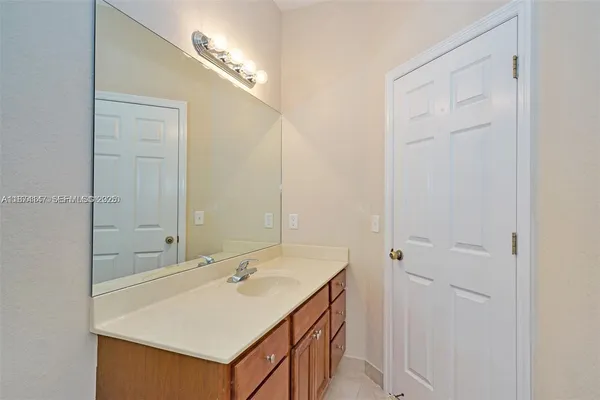 a bathroom with a sink vanity and a mirror