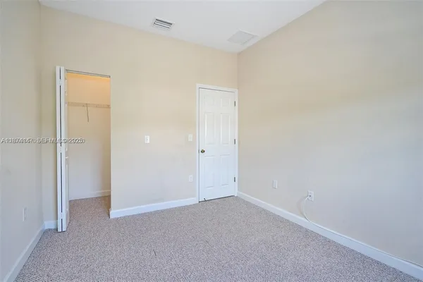 an empty room with closet area