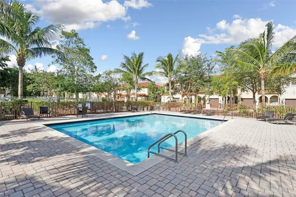a view of swimming pool with outdoor seating and plants