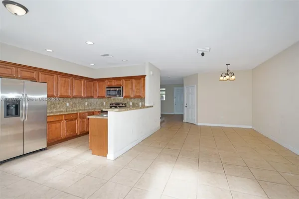 a large kitchen with cabinets and stainless steel appliances