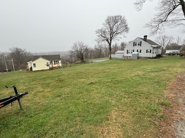 27 Havana Road Worcester, MA 01603 - Photo 2 of 6 a view of a white house with a yard and sitting area