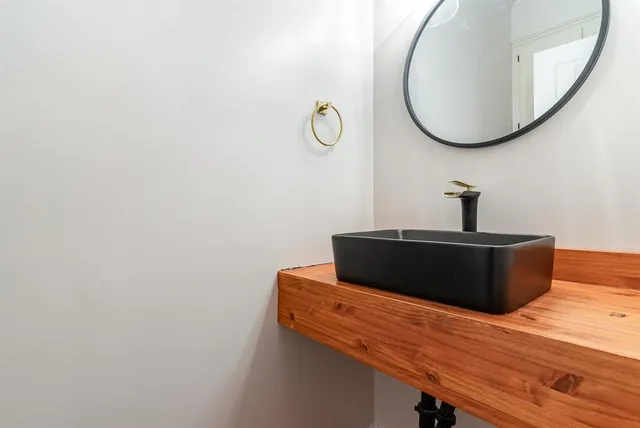 a view of a room with wooden floor and mirror