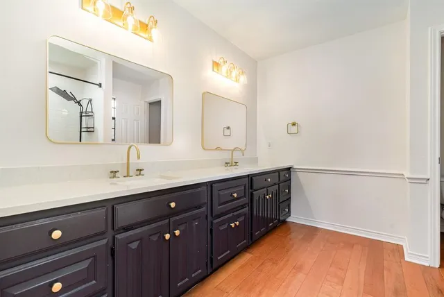 a spacious bathroom with a double vanity sink and a mirror