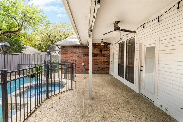 a view of a porch with wooden floor and gate