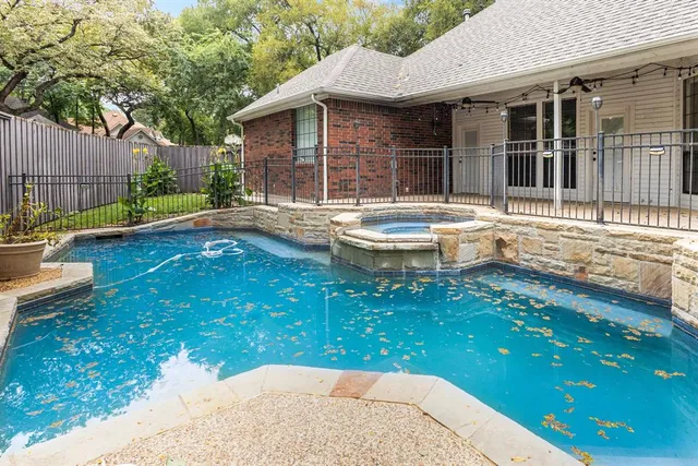 a view of a house with swimming pool and sitting area