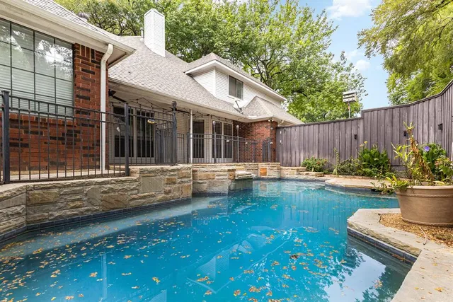 a swimming pool with patio outdoor seating and yard
