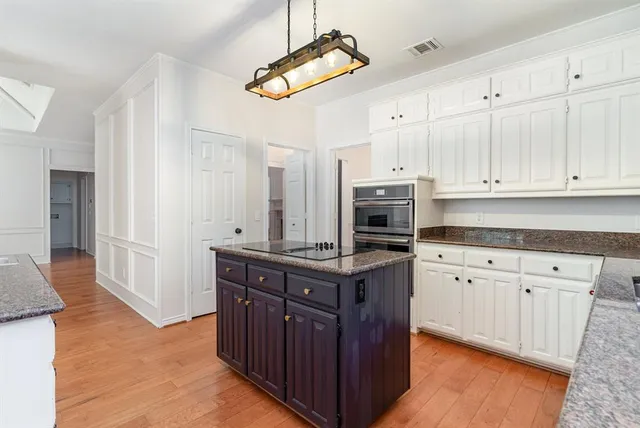 a kitchen with stainless steel appliances granite countertop a stove a sink dishwasher and a refrigerator