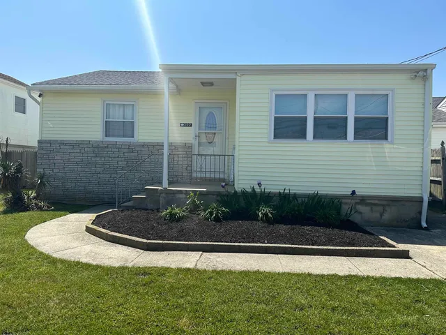 a view of brick house with a yard