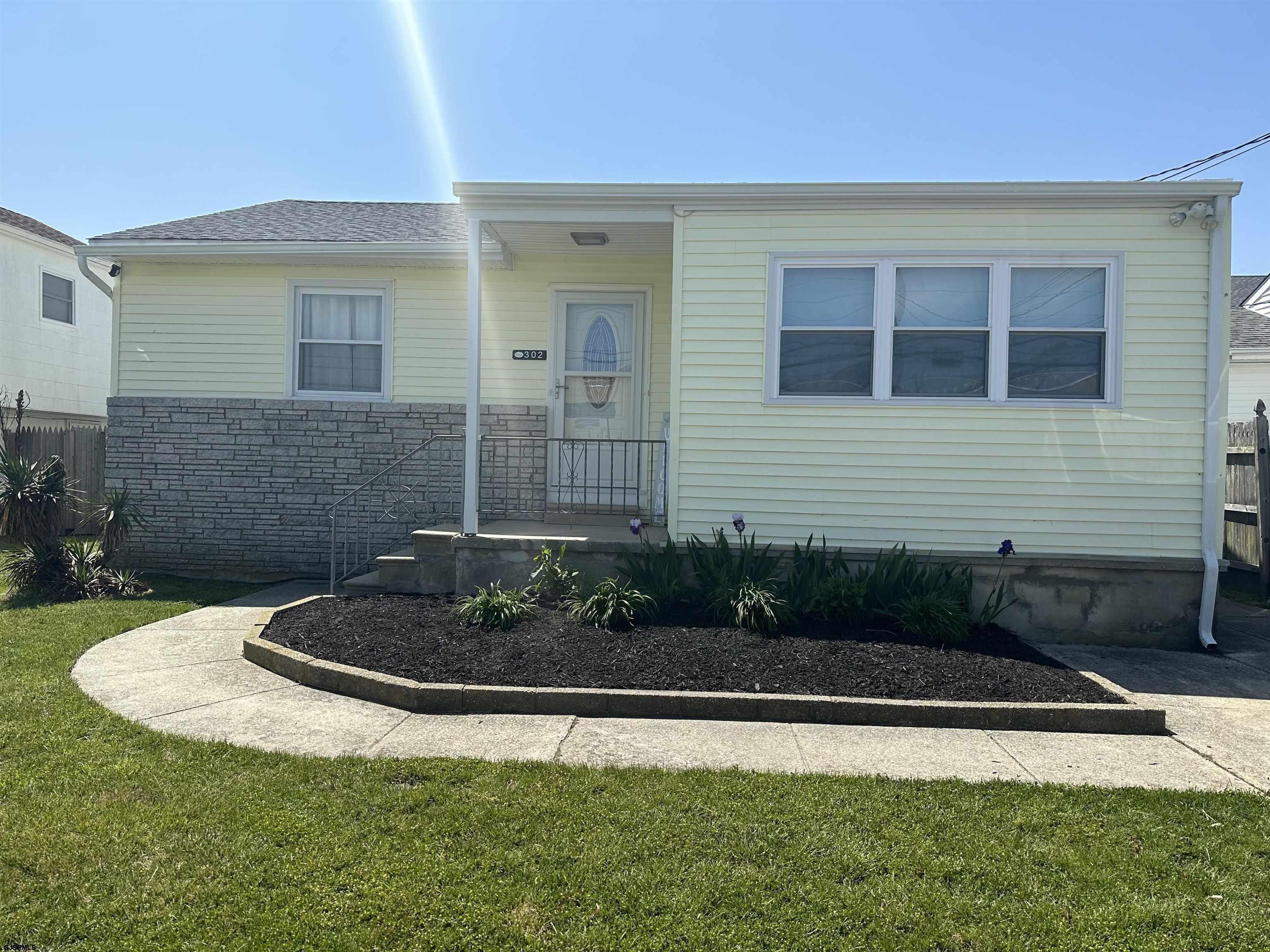 302 Sheridan Place Brigantine, NJ 08203 - Photo 1 of 15 a view of brick house with a yard