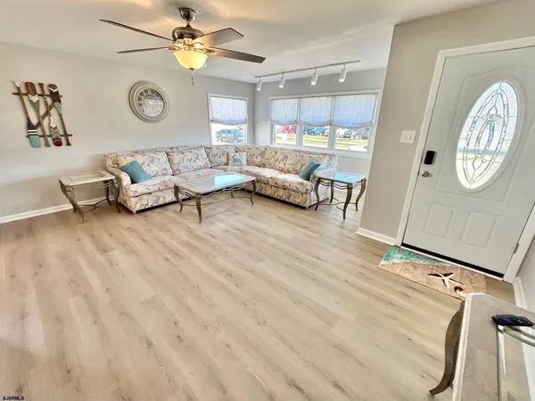 a living room with furniture and a clock