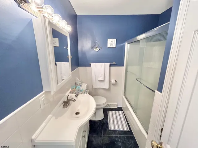 a bathroom with a sink a mirror and a toilet