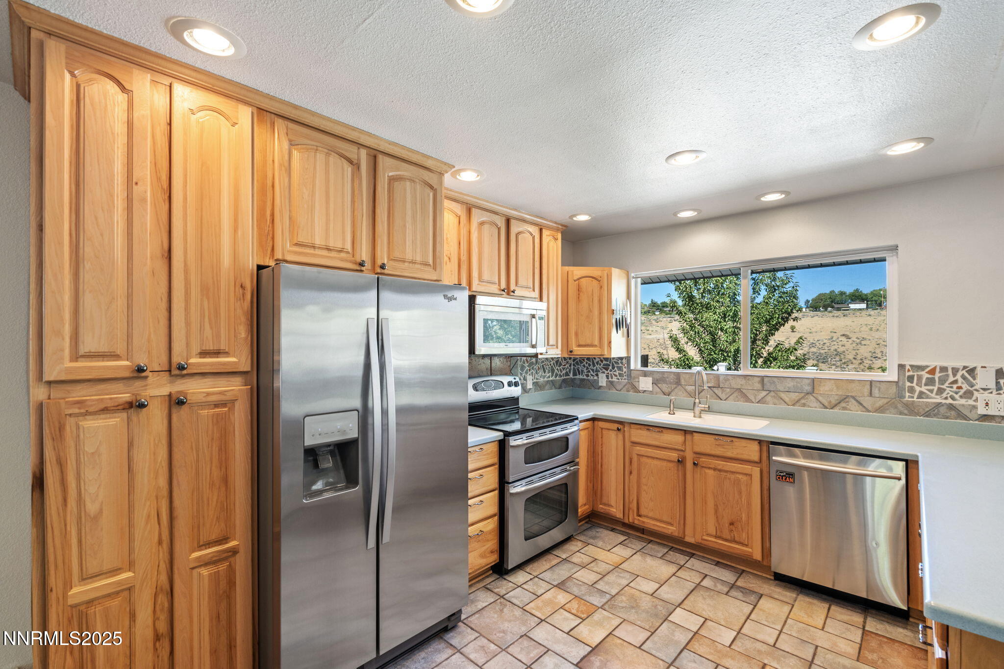 2275 Solari Drive Reno, NV 89509 - Photo 14 of 52 a kitchen with stainless steel appliances granite countertop a refrigerator and a sink