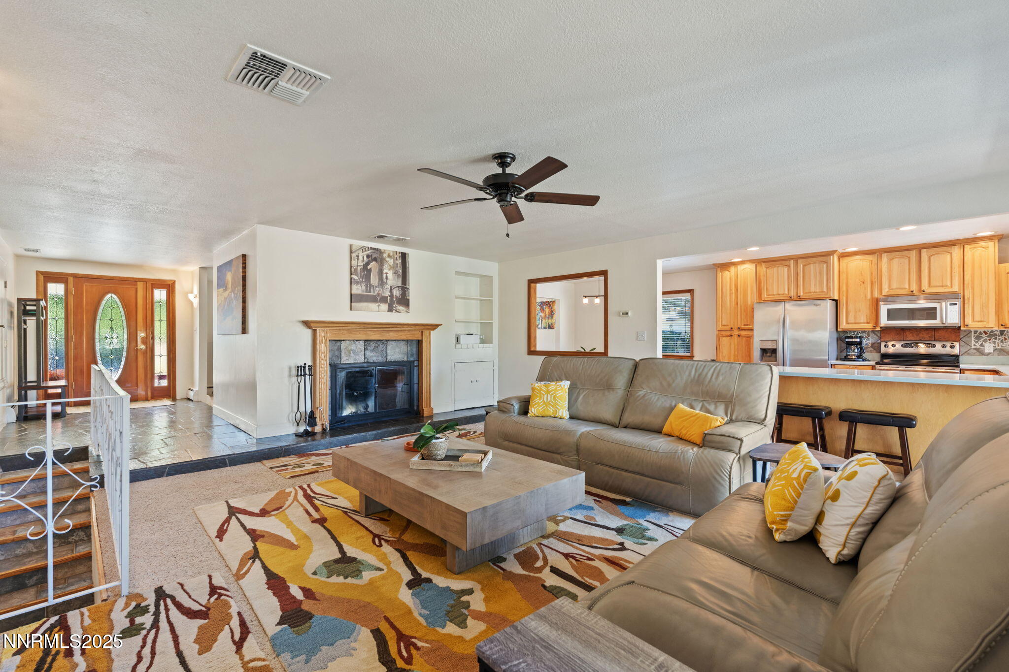 2275 Solari Drive Reno, NV 89509 - Photo 16 of 52 a living room with furniture fireplace and a large window