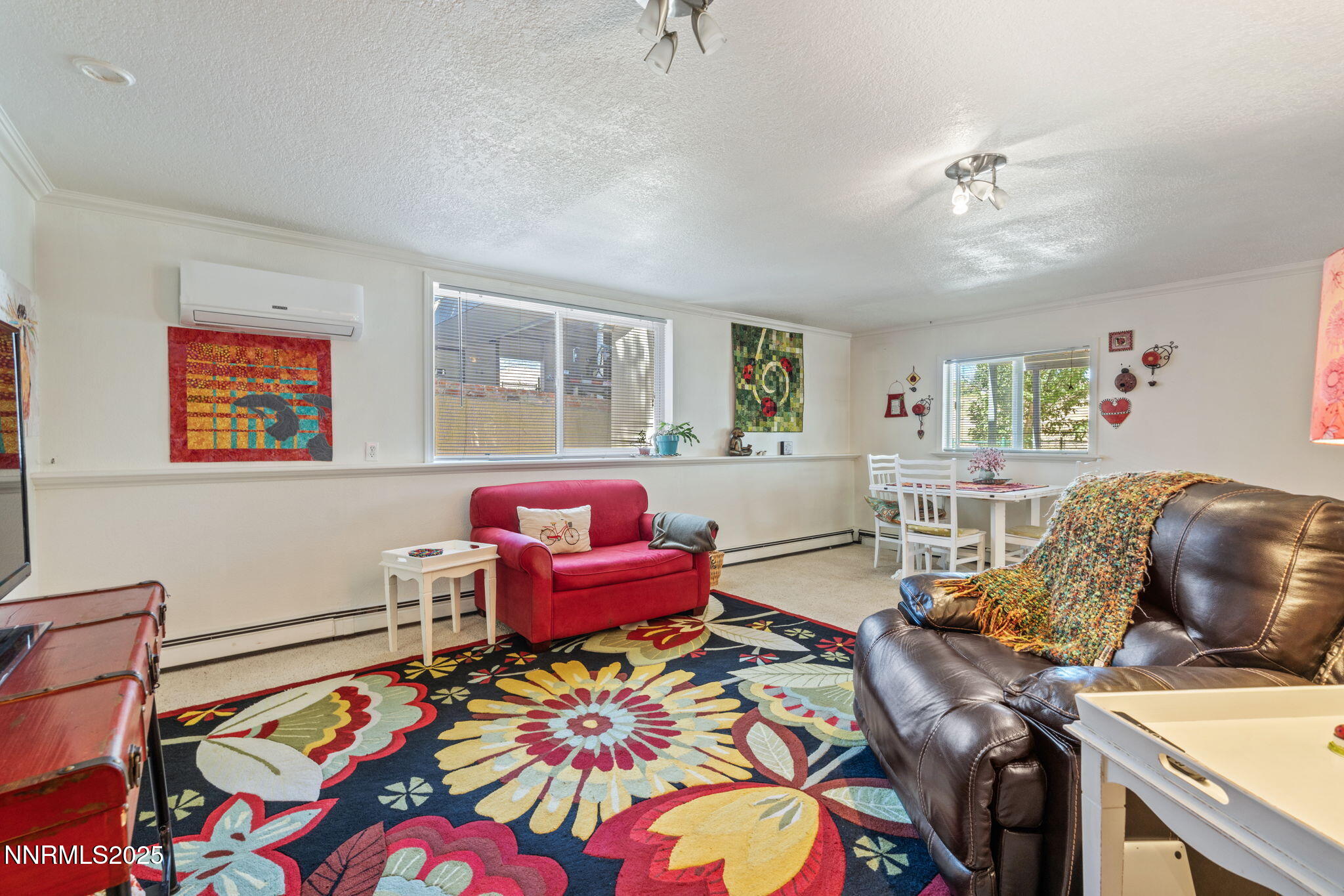 2275 Solari Drive Reno, NV 89509 - Photo 33 of 52 a living room with furniture and a baby crib