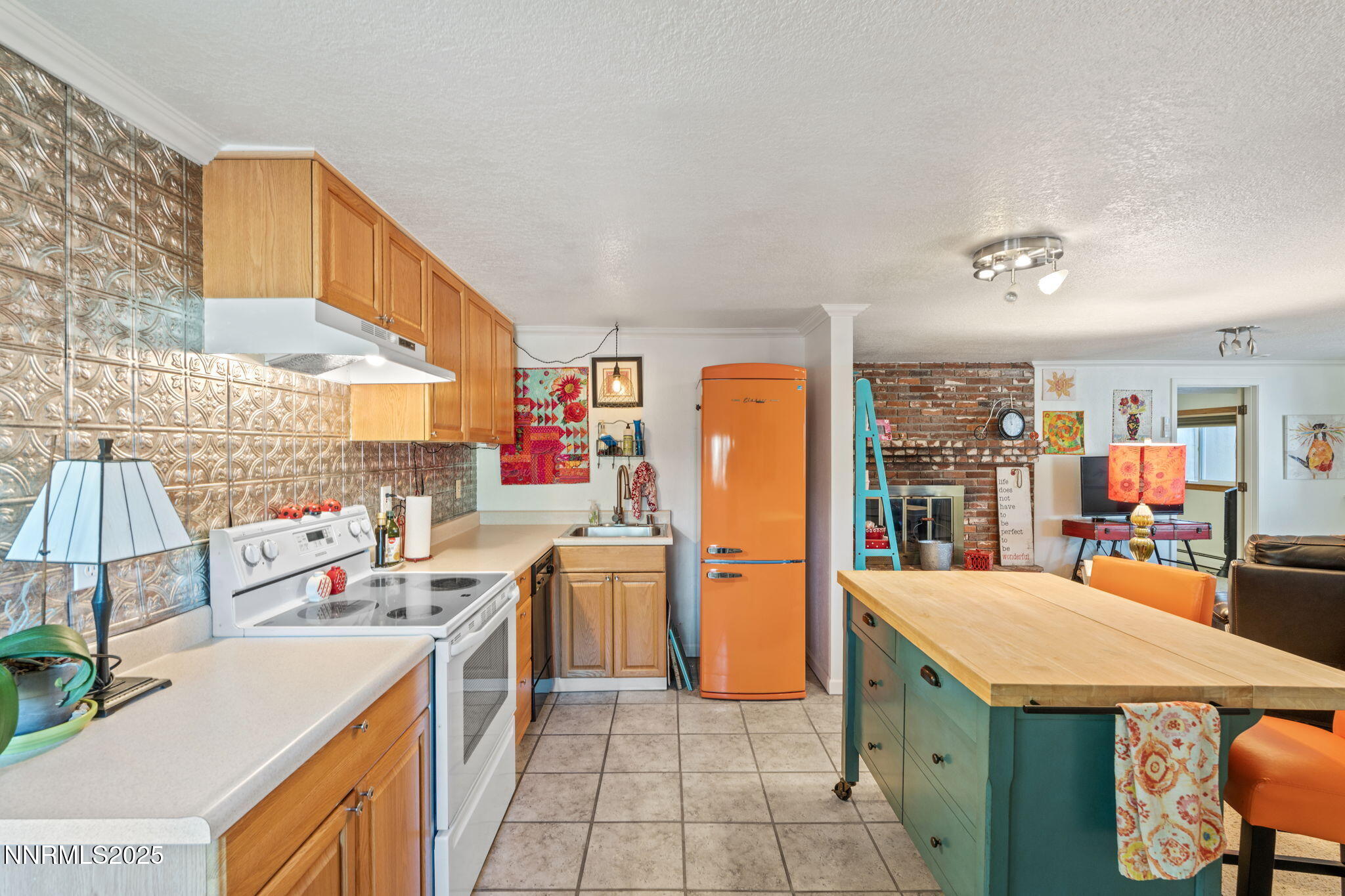 2275 Solari Drive Reno, NV 89509 - Photo 35 of 52 a kitchen that has a lot of cabinets a sink and a refrigerator