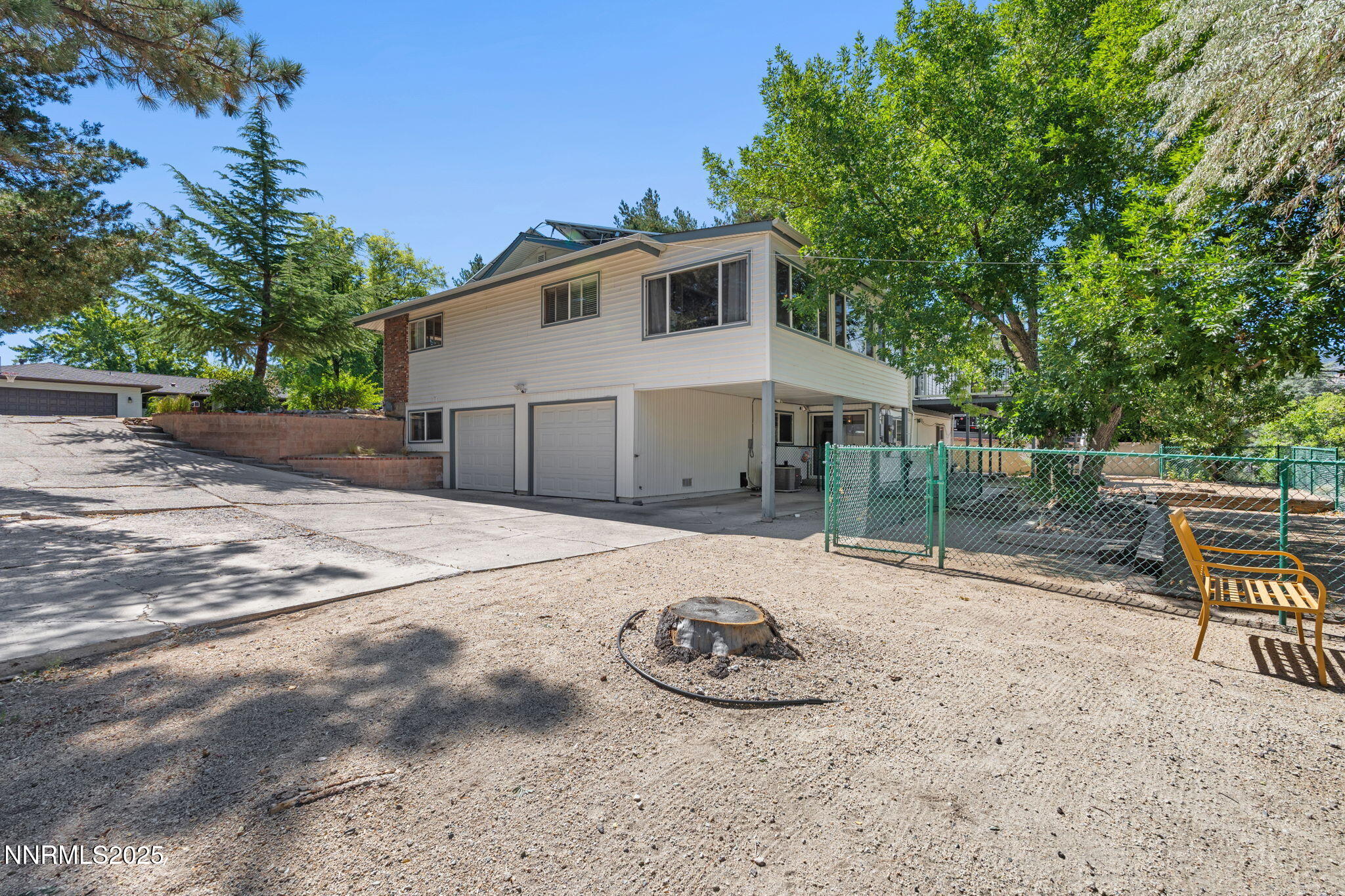 2275 Solari Drive Reno, NV 89509 - Photo 43 of 52 a view of a backyard with table and chairs and wooden fence