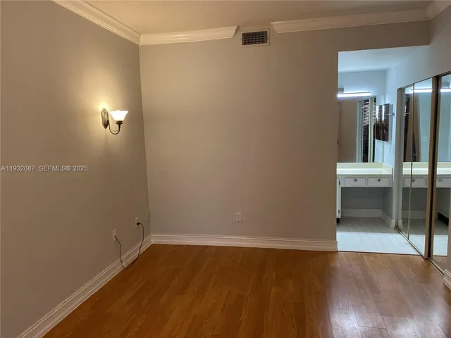 a view of a room with wooden floor