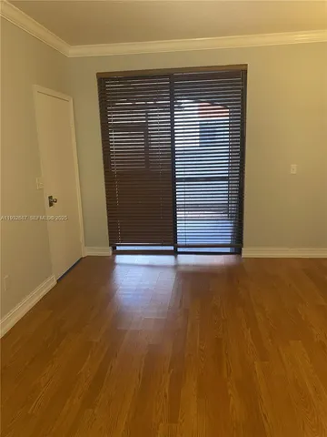 a view of room with wooden floor