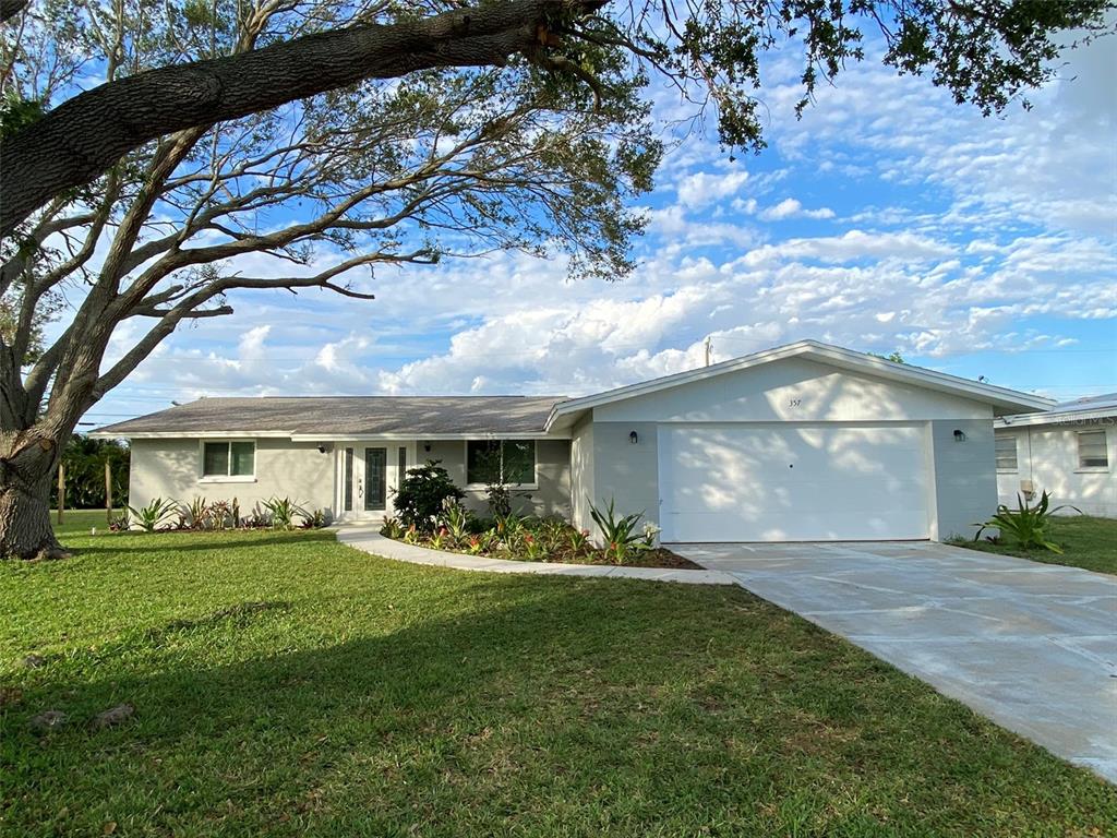 357 Pine Tree Road Venice, FL 34293 - Photo 1 of 1 a front view of a house with a garden and yard