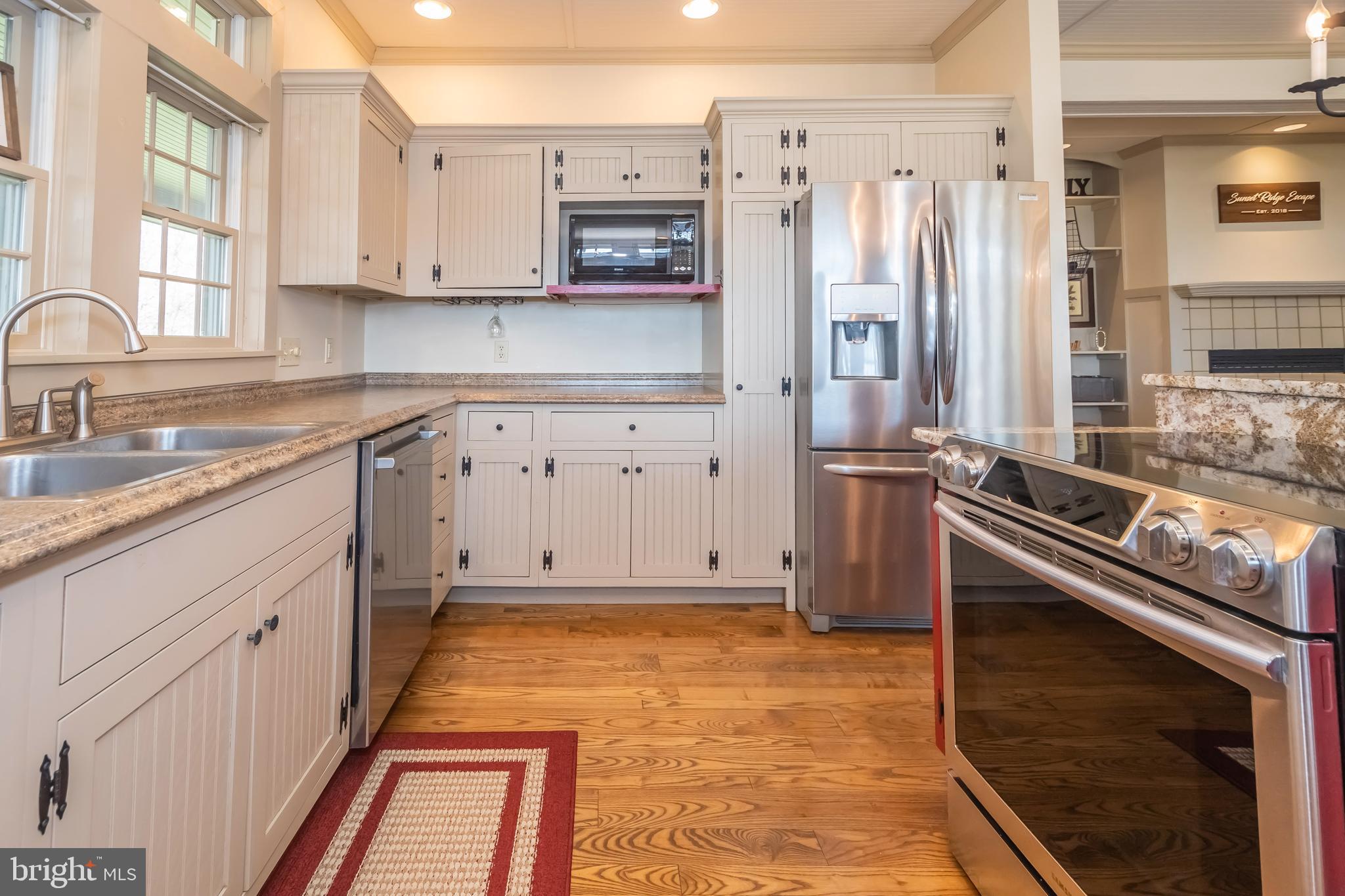 726 Sunset Ridge Drive McHenry, MD 21541 - Photo 12 of 50 a kitchen with stainless steel appliances a stove a sink and a refrigerator