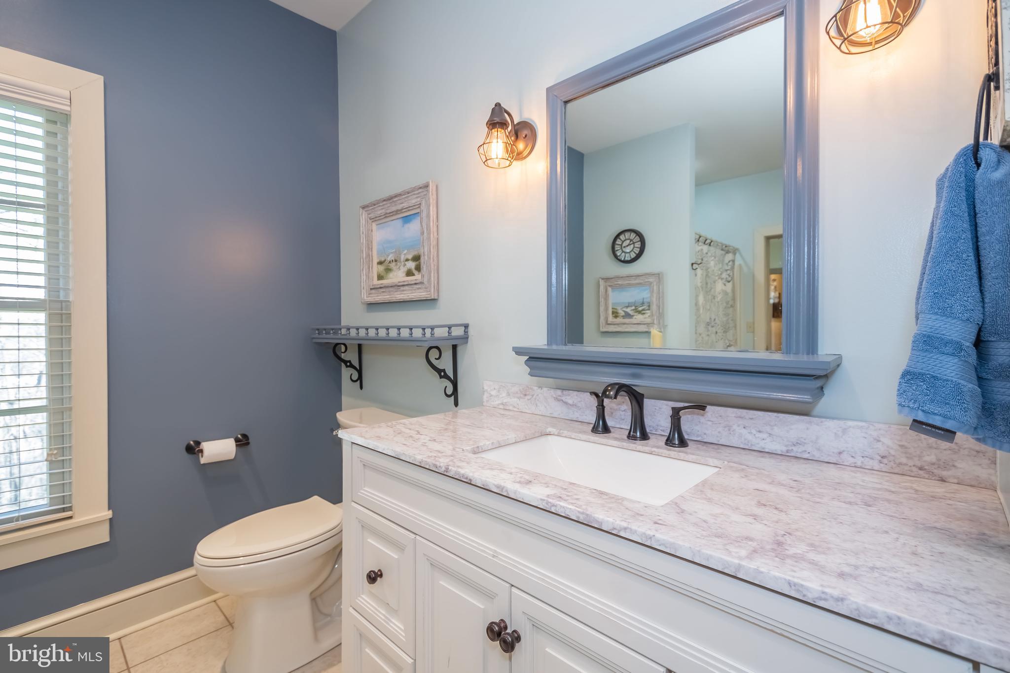 726 Sunset Ridge Drive McHenry, MD 21541 - Photo 22 of 50 a bathroom with a granite countertop toilet sink and mirror