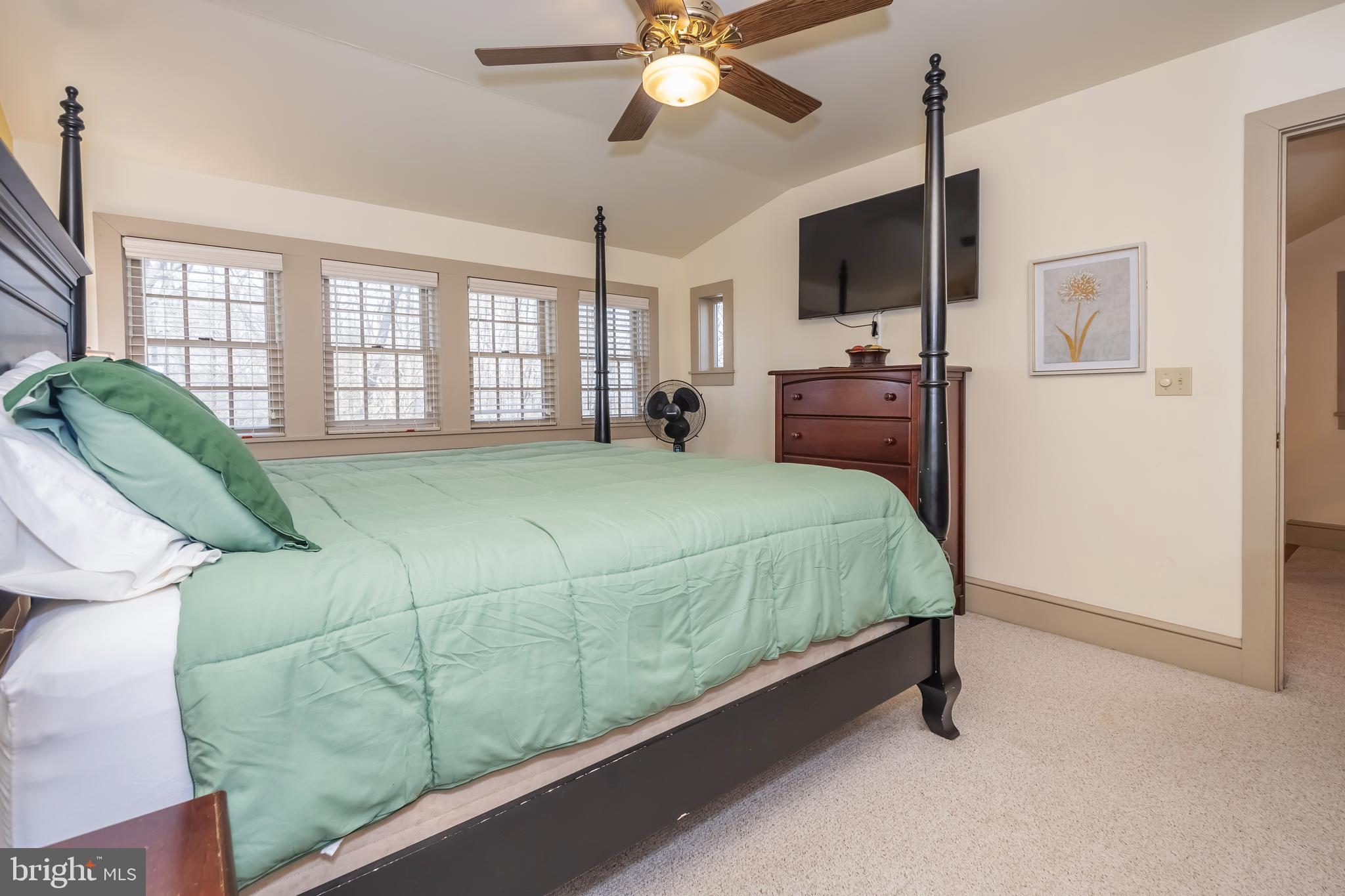 726 Sunset Ridge Drive McHenry, MD 21541 - Photo 35 of 50 a spacious bedroom with a bed flat screen tv and windows