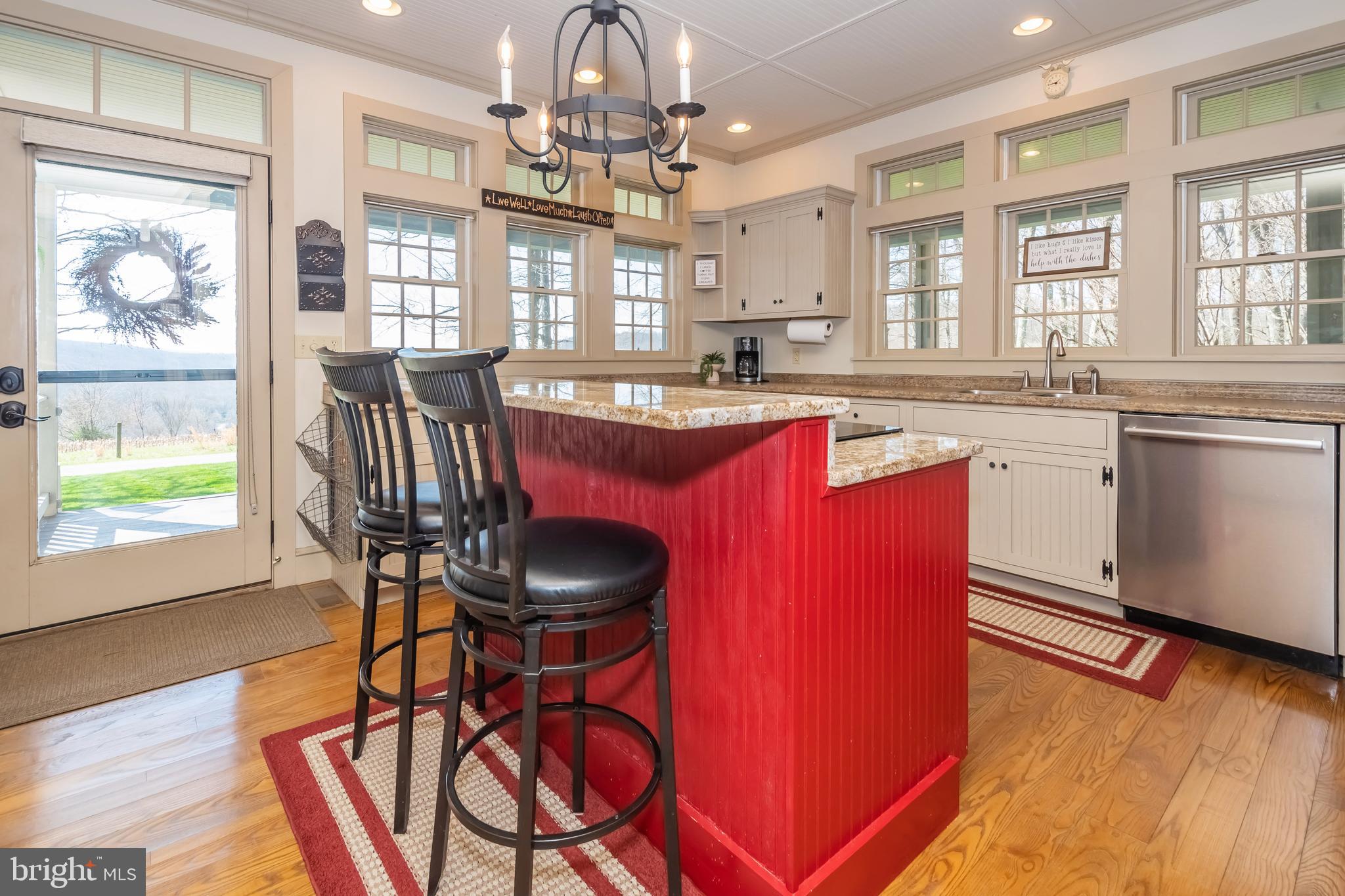 726 Sunset Ridge Drive McHenry, MD 21541 - Photo 8 of 50 a kitchen with stainless steel appliances granite countertop a stove top oven a dining table and chairs with wooden floor