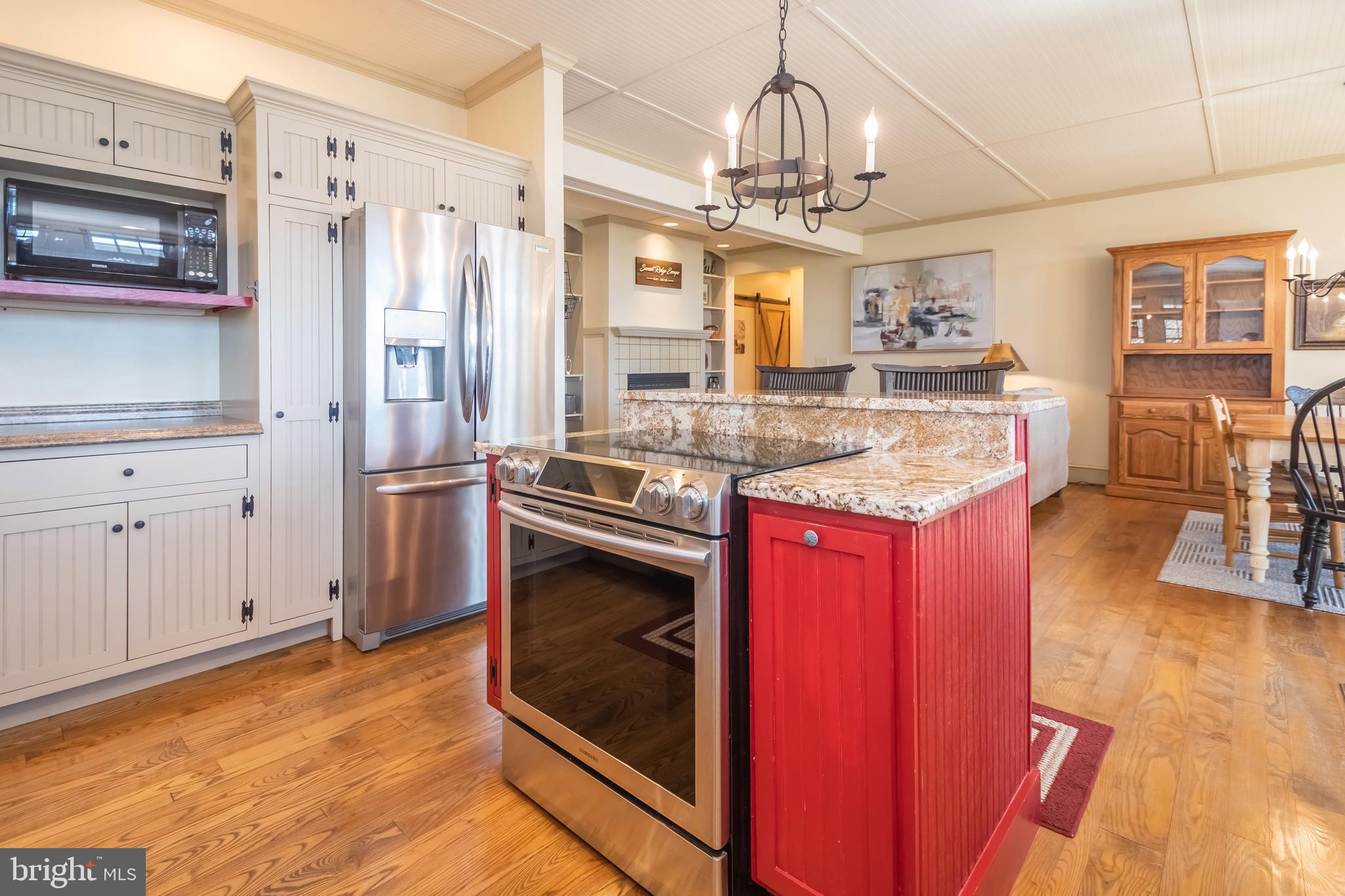 726 Sunset Ridge Drive McHenry, MD 21541 - Photo 9 of 50 a kitchen with stainless steel appliances granite countertop a refrigerator a stove and a wooden floors