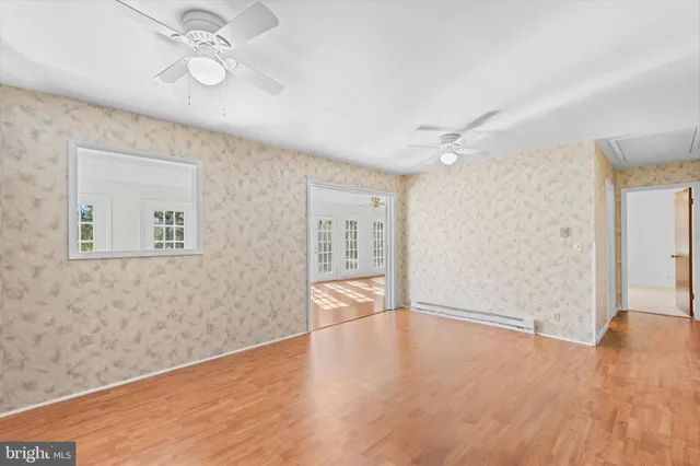 wooden floor in an empty room with a window