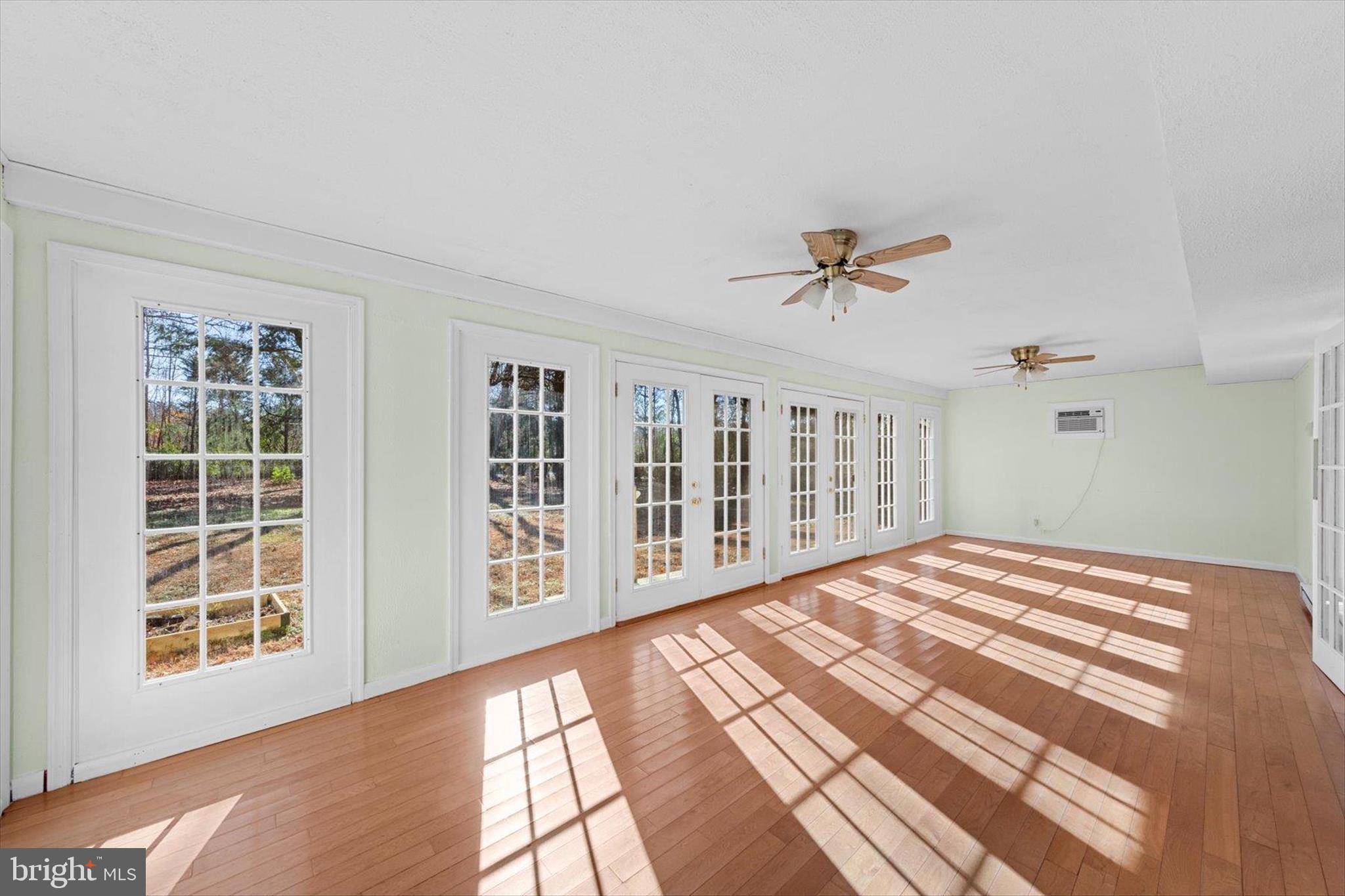 12468 Taylor Mill Road Laurel, DE 19956 - Photo 15 of 37 a view of a bedroom with wooden floor and a ceiling fan