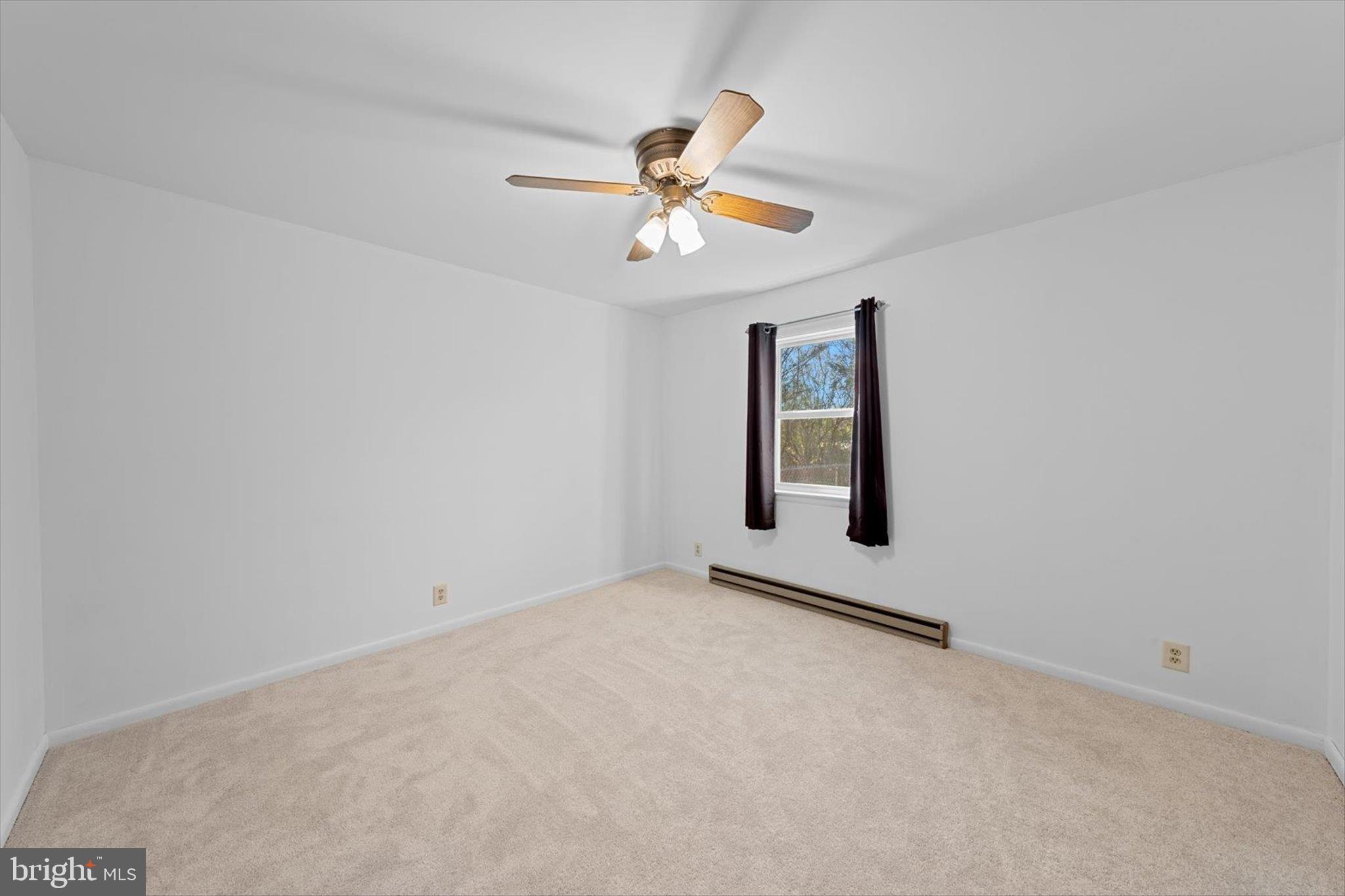 12468 Taylor Mill Road Laurel, DE 19956 - Photo 20 of 37 an empty room with windows and fan