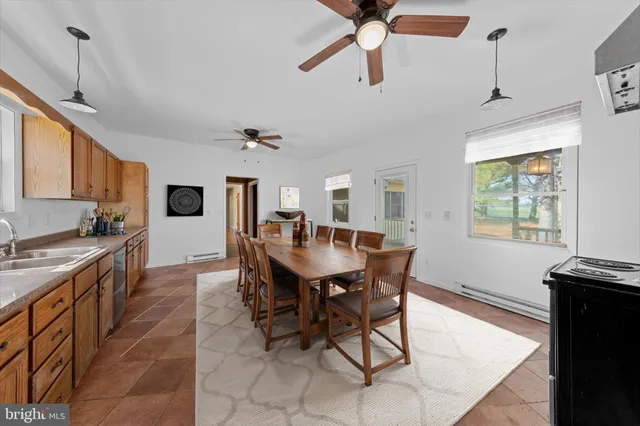 a large white kitchen with a stove a refrigerator and a stove top oven