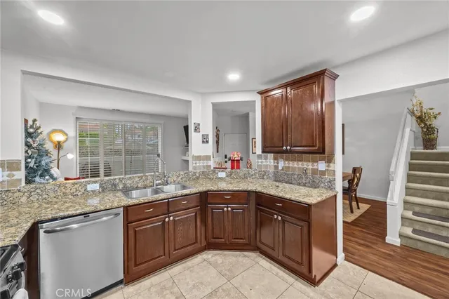 a kitchen with stainless steel appliances granite countertop a refrigerator stove and sink