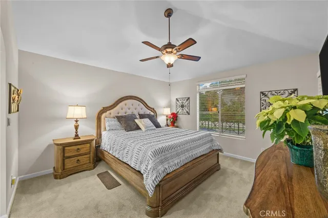 a bedroom with a bed and a television