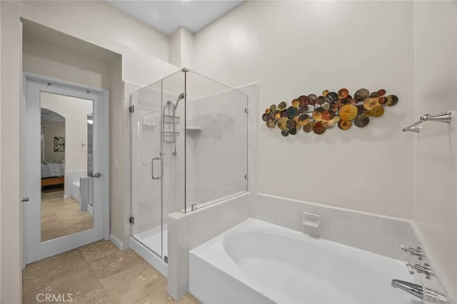 a bedroom with furniture and a flat screen tv