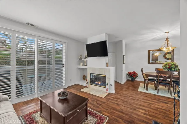 a living room with furniture a flat screen tv and a fireplace