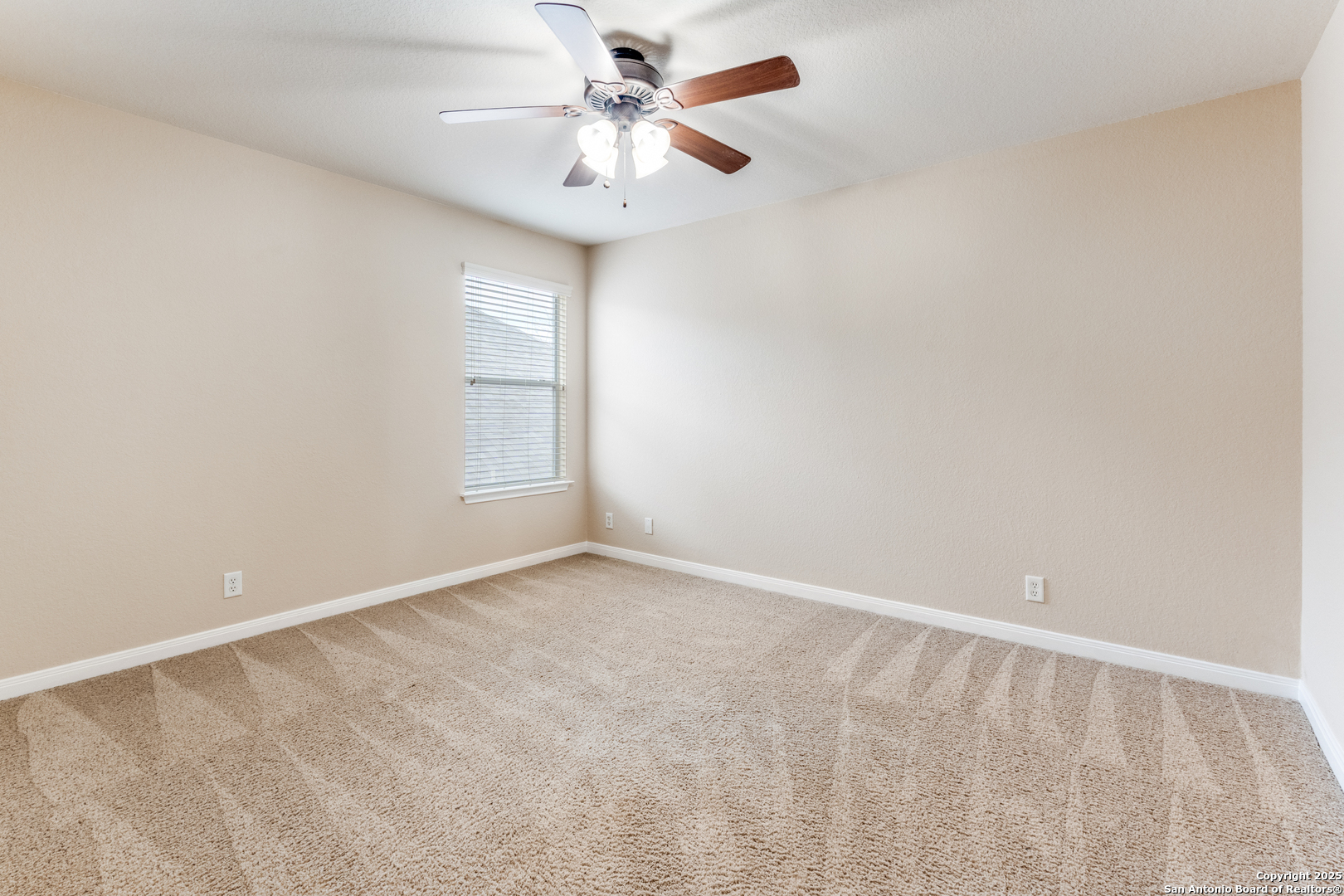 1935 Walter Raleigh Windcrest, TX 78239 - Photo 15 of 27 an empty room with windows and fan