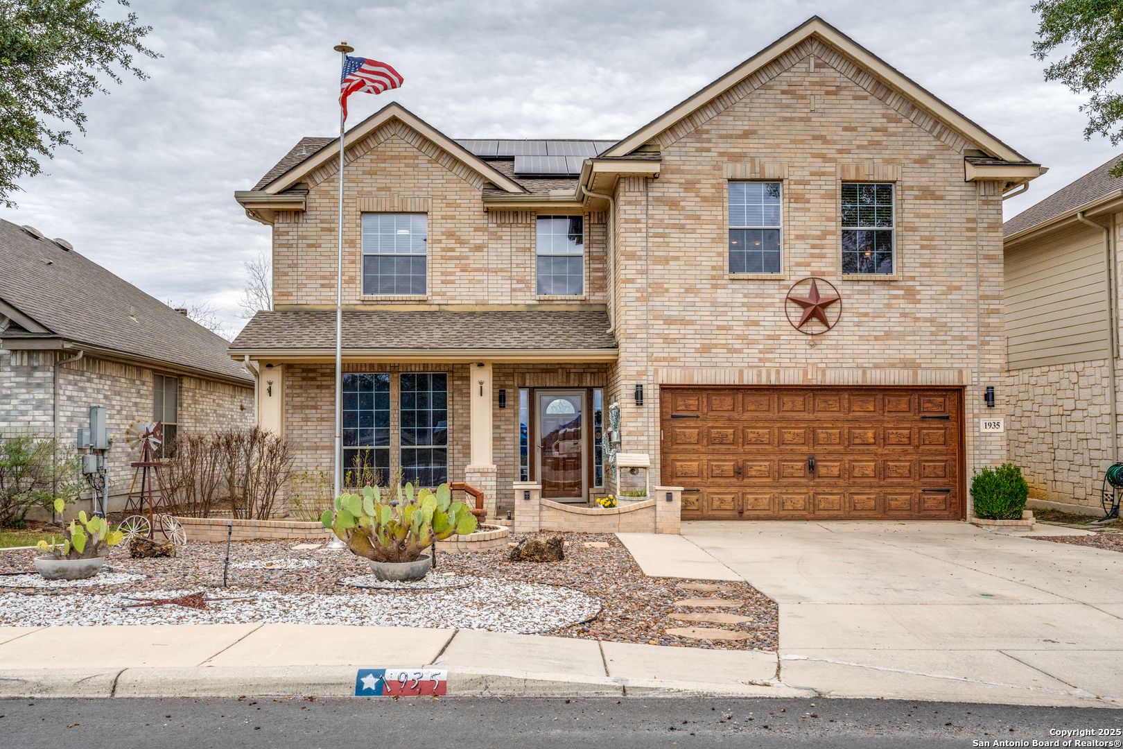 1935 Walter Raleigh Windcrest, TX 78239 - Photo 2 of 27 a front view of a house with garden
