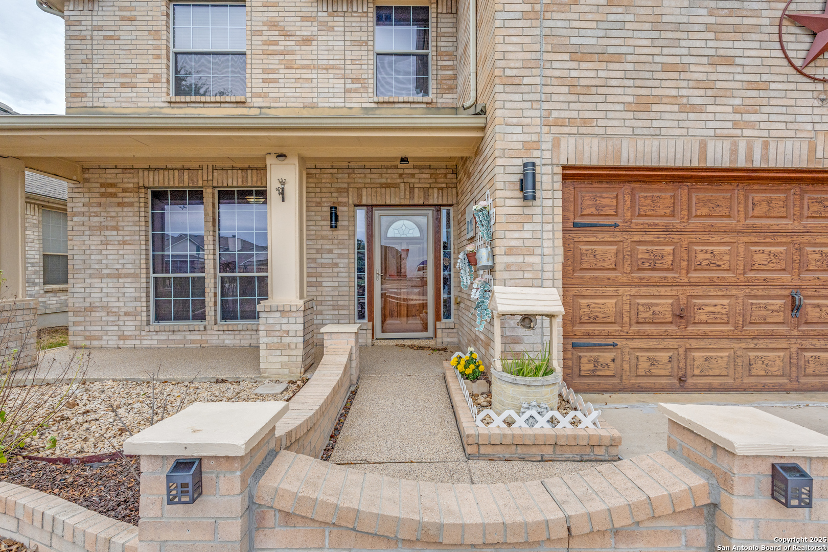 1935 Walter Raleigh Windcrest, TX 78239 - Photo 3 of 27 front view of a brick house with a potted plant