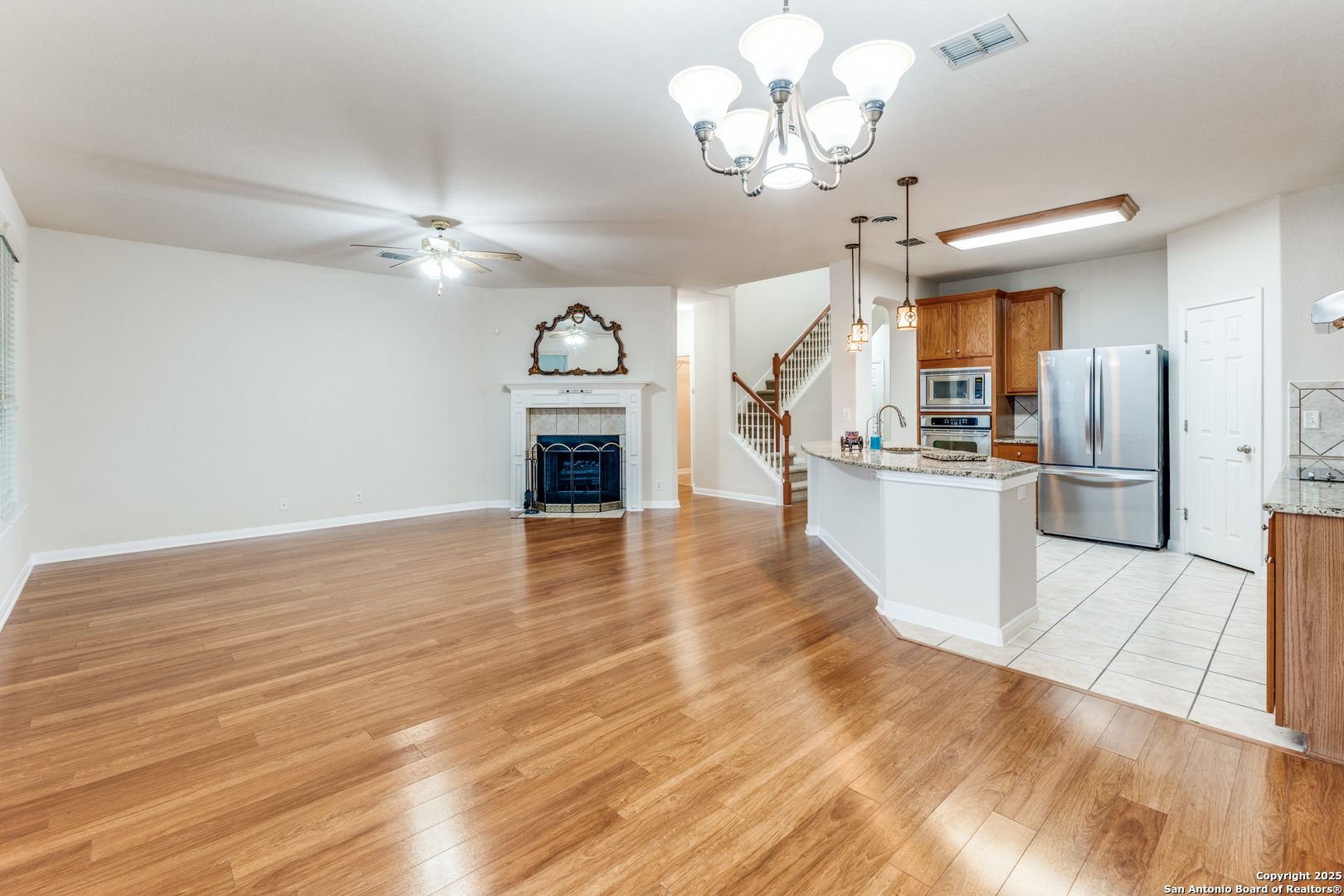1935 Walter Raleigh Windcrest, TX 78239 - Photo 6 of 27 a view of a kitchen with a stove cabinets and a wooden floor