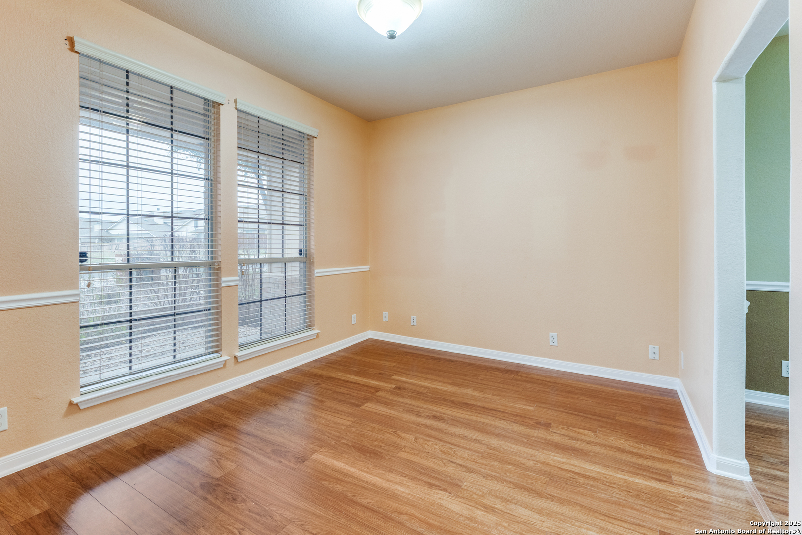 1935 Walter Raleigh Windcrest, TX 78239 - Photo 8 of 27 a view of an empty room with wooden floor and a window